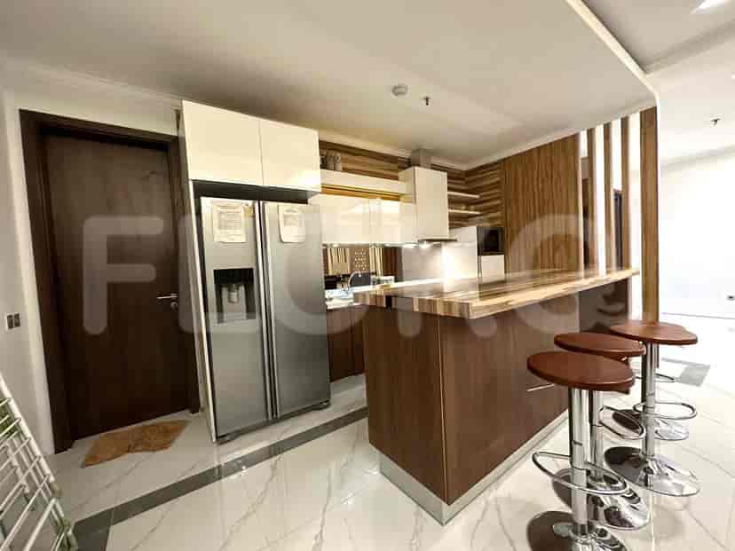 A kitchen featuring a bar counter, stools, and modern appliances.