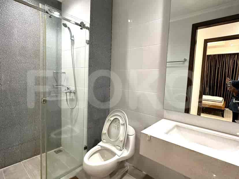A modern bathroom with a shower, toilet, and sink.