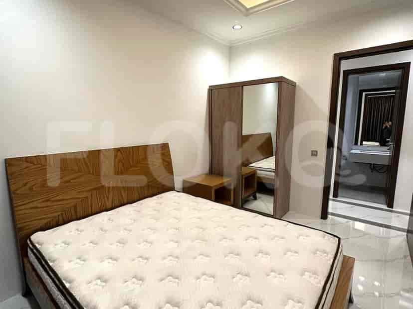 A cozy bedroom with a bed and a nightstand, featuring a modern style and minimalist design.