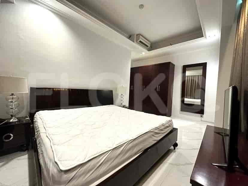 A bedroom with a bed, mirror, and wardrobe, featuring a modern style.