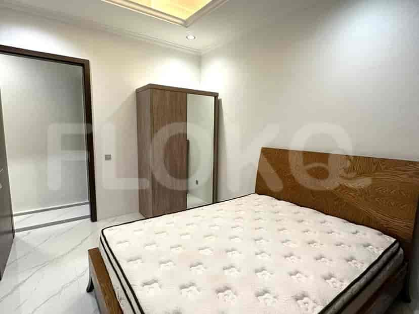 A bedroom with a bed, wardrobe, and mirror, featuring a modern style.