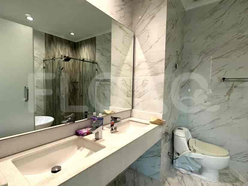 A luxurious bathroom with a bathtub, double sink, and large mirror.