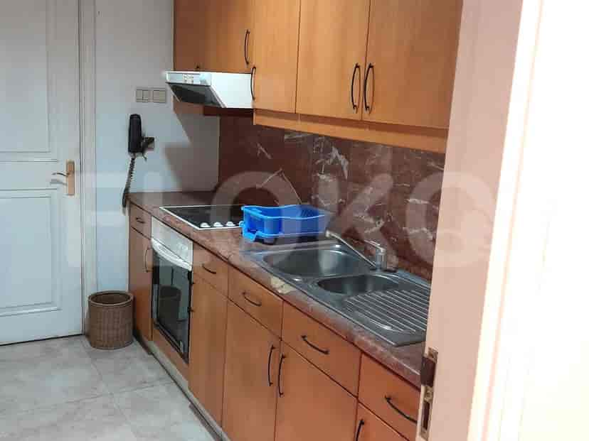 A kitchen with wooden cabinets and an electric stove.