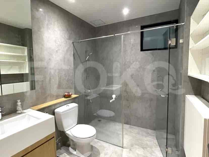 Spacious bathroom showcasing a glass shower, modern sink, and a toilet.