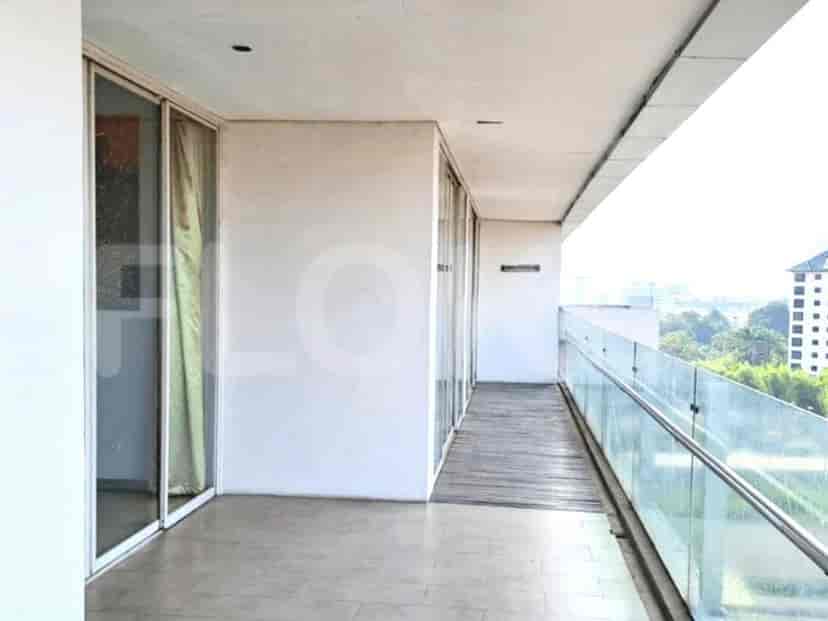 A balcony with a view, with glass railings.