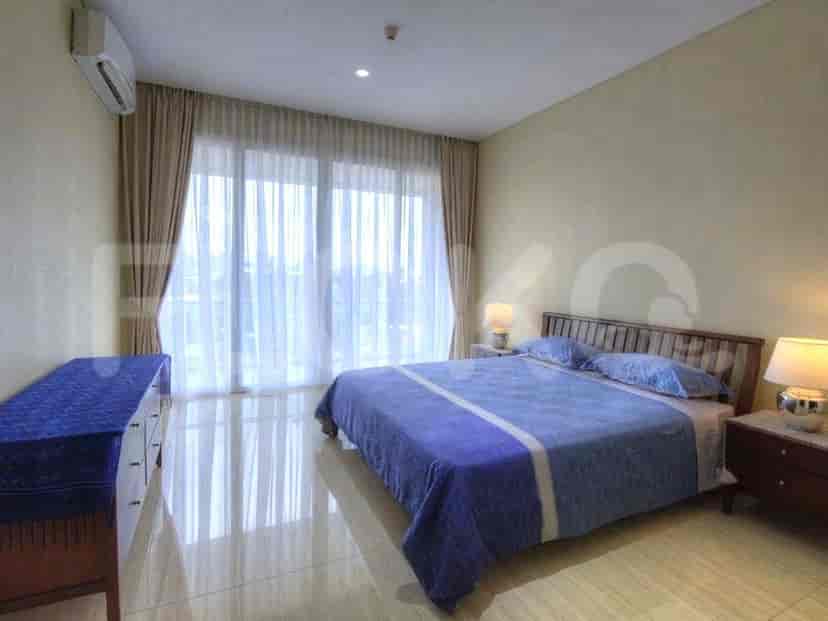A cozy bedroom featuring a queen-sized bed, large windows, and a modern design.