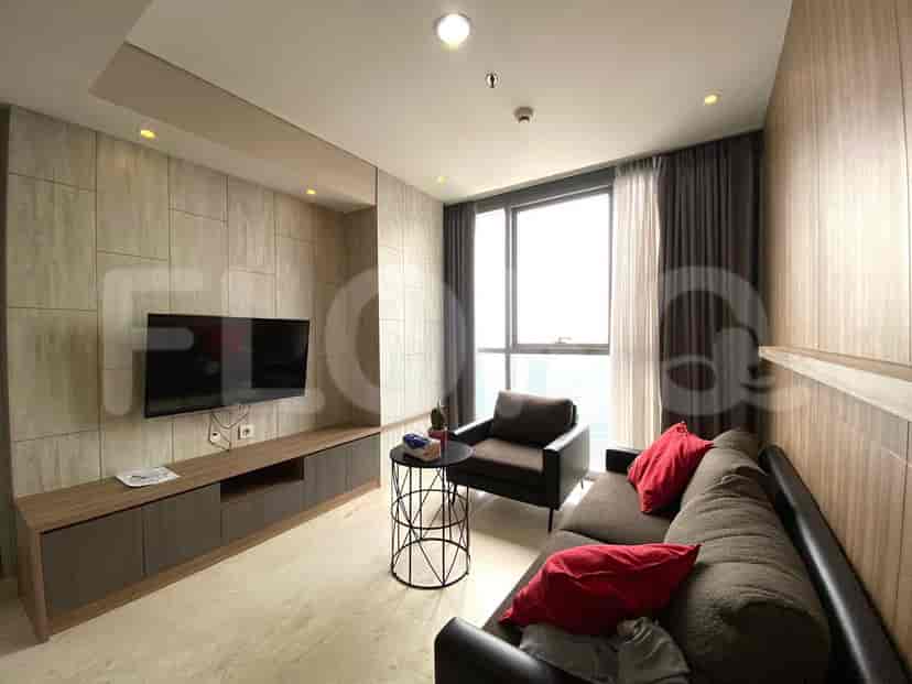 Living room with a sofa, armchair, TV, and coffee table, showing the same design elements as the first image.
