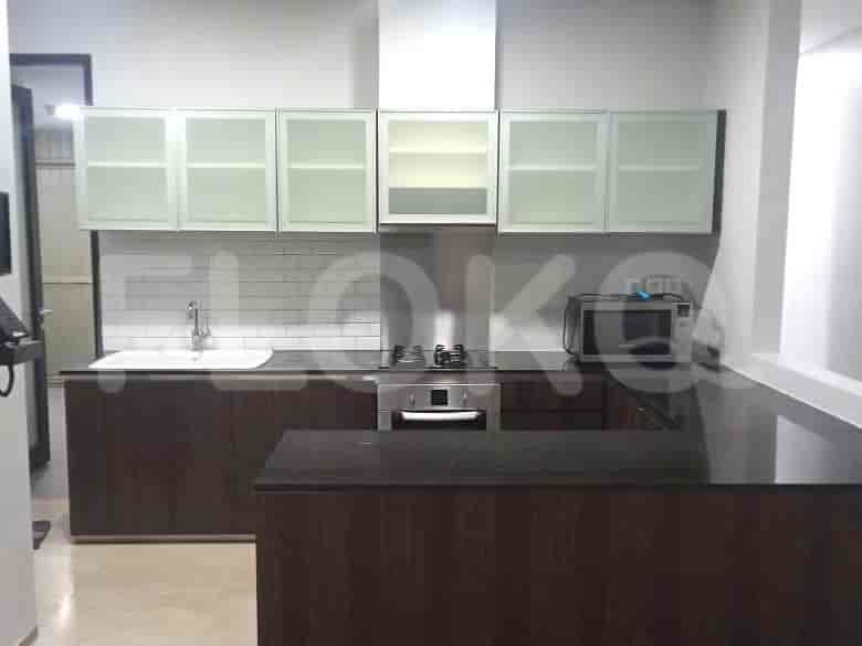 Modern kitchen with wooden cabinets, white tile backsplash, and stainless steel appliances.