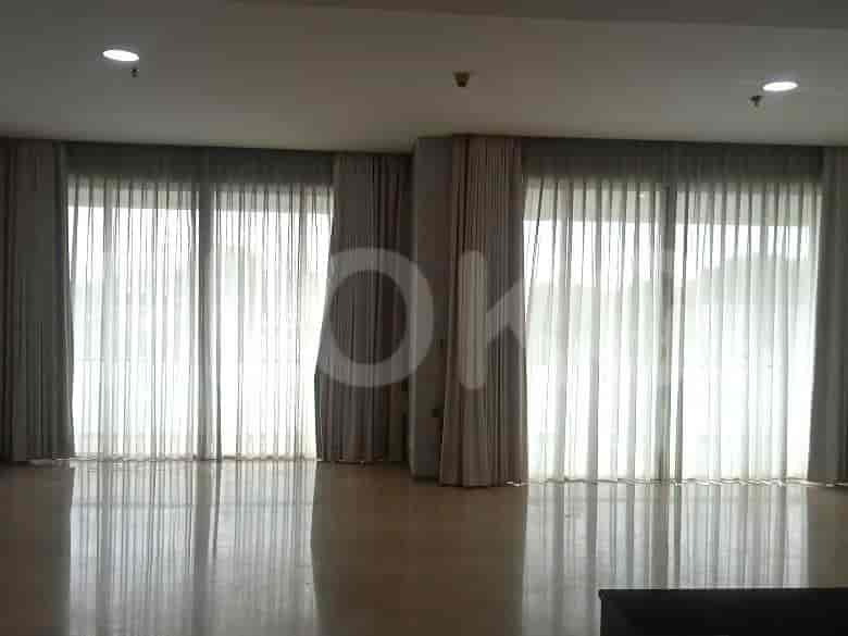 Living room with curtains and light-colored flooring.
