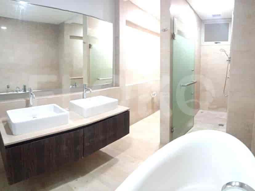 Large bathroom with a bathtub, double sink, and a separate shower.