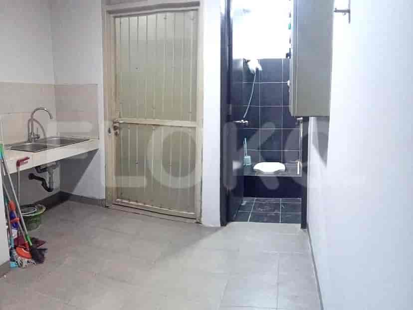 Utility room with a sink and a toilet.
