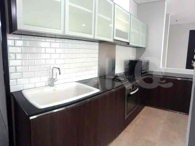 Kitchen with wooden cabinets and white tile backsplash.