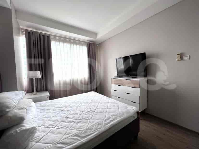 Kamar tidur yang nyaman dengan tempat tidur ganda, meja samping tempat tidur, dan jendela dengan gorden.