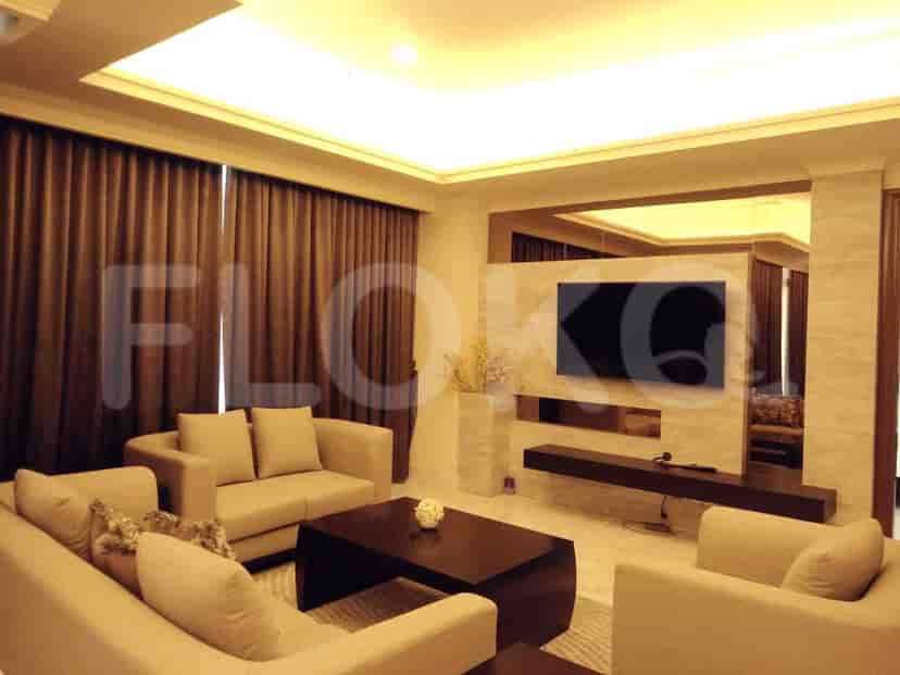 A luxurious living room with a beige sofa set, dark wood coffee table, and a wall-mounted TV.