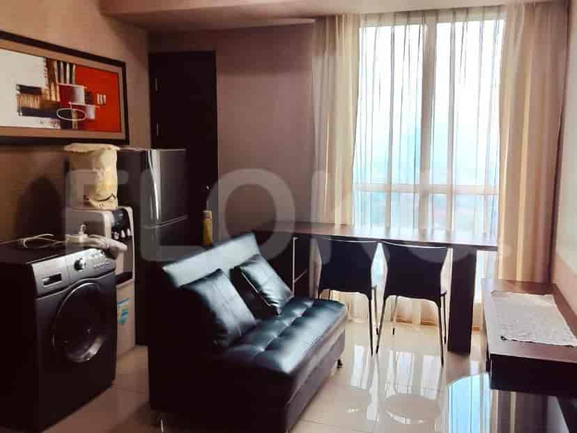 Living room featuring a sofa, dining table, and appliances.