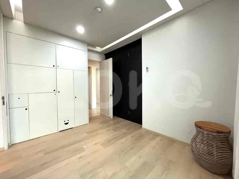 Bedroom with built-in closet, hardwood flooring, and modern decor.