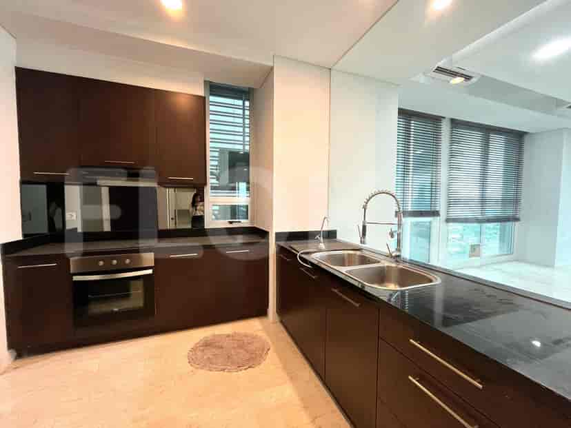 Modern kitchen with dark cabinetry, stainless steel appliances, and a large mirror.