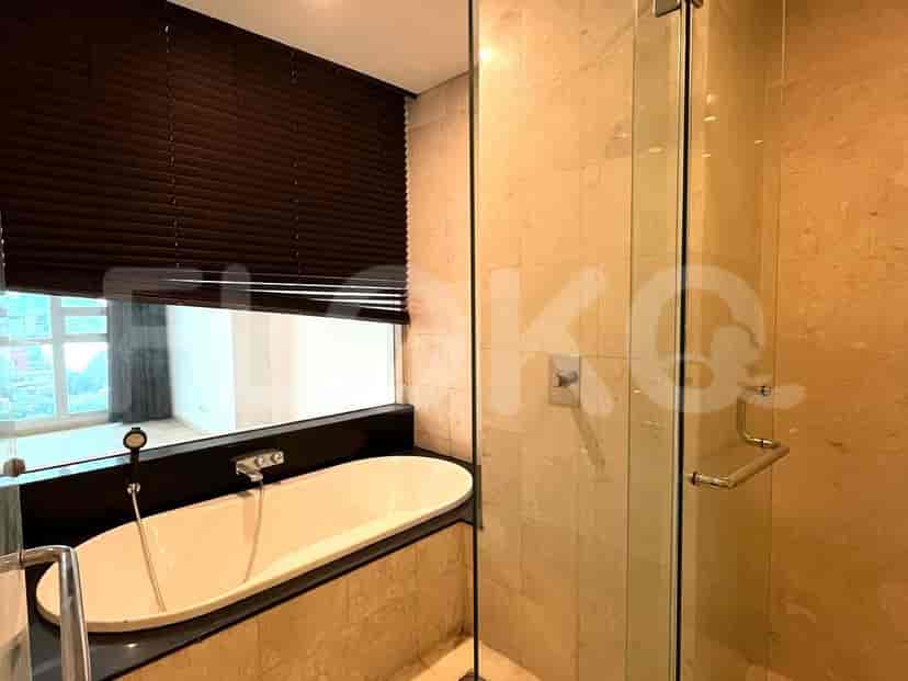 Luxurious bathroom with bathtub and glass-enclosed shower.