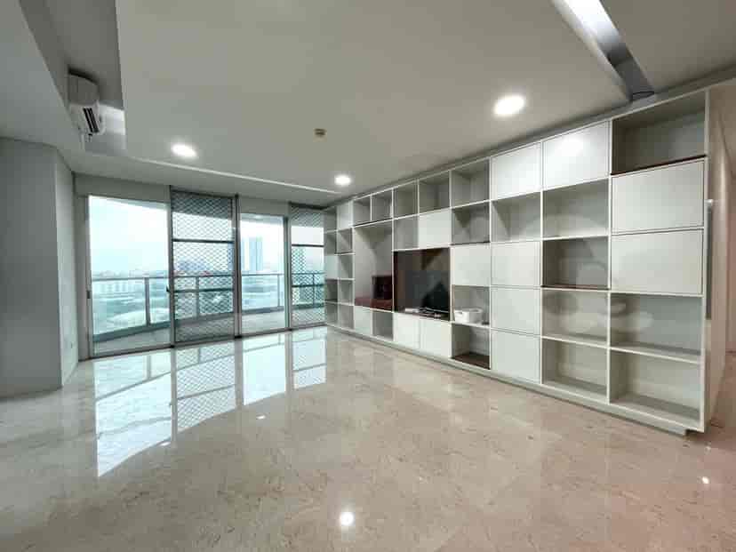 Modern living room with large windows, built-in shelving, and marble flooring.