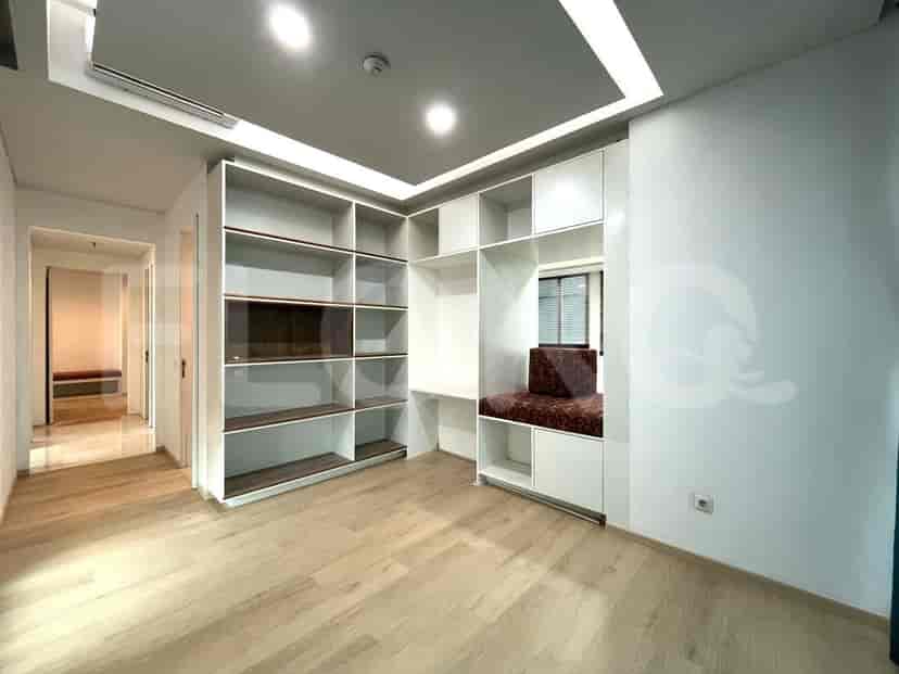 Living room with built-in shelving, a study nook, and hardwood flooring.