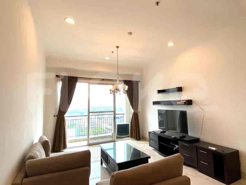 A dining area with a wooden table and chairs, and a glimpse into the kitchen.