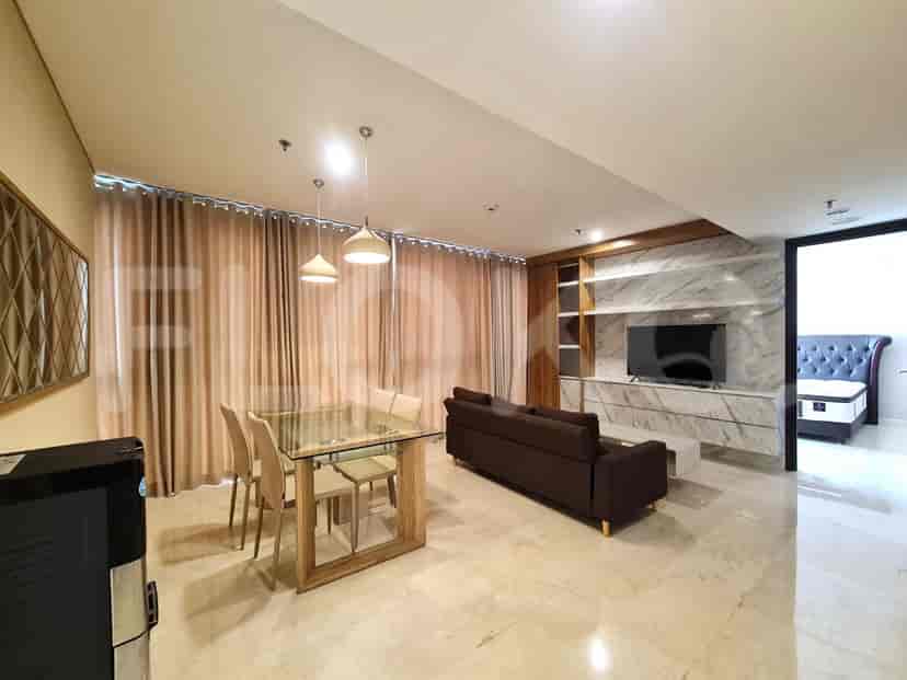 Modern living area with a sofa, dining table, and marble accents.