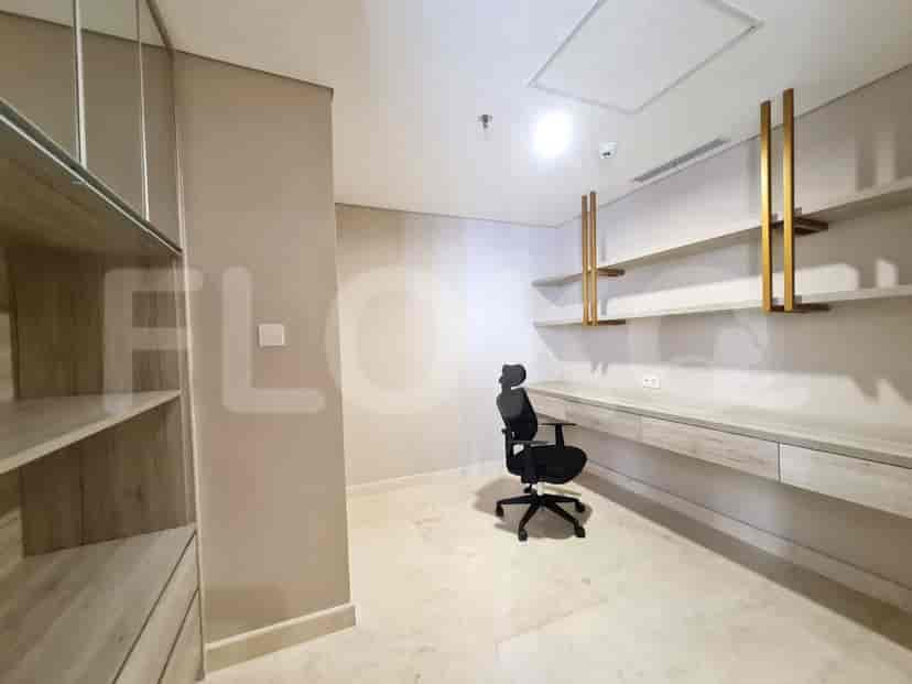 Office area with desk, shelves, and chair.