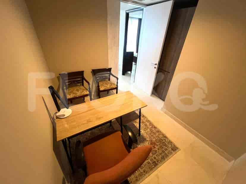 Home office with desk and two chairs.