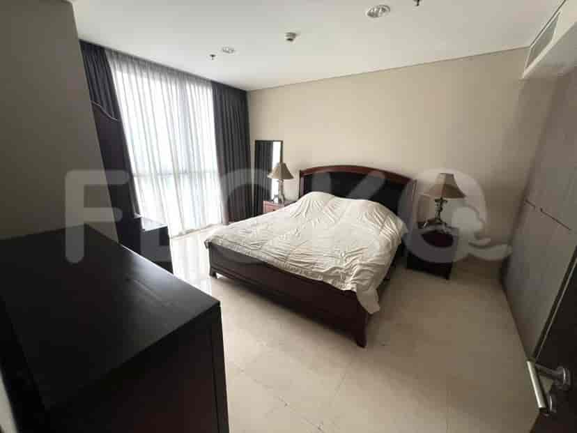 Master bedroom with a king-sized bed and dresser.