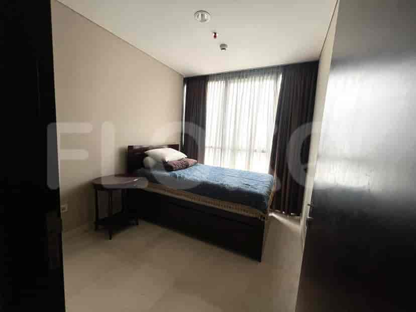 Guest bedroom with bed and side table.