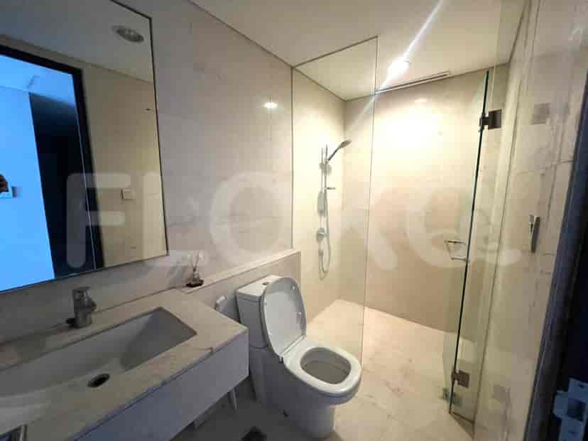 Modern bathroom with shower and toilet.
