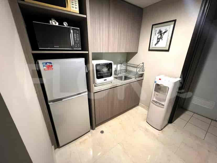 Kitchenette with refrigerator, microwave, and sink.