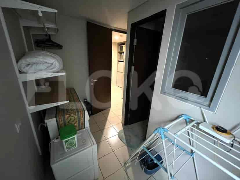 Laundry room with drying rack and storage.