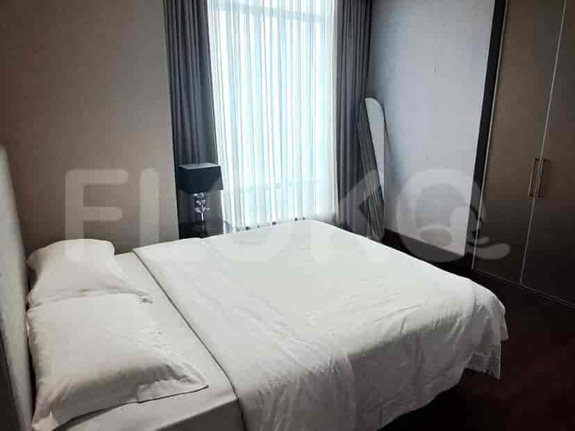 Bedroom with a bed, curtains, and a lamp.