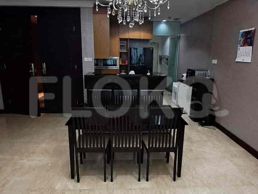 Dining area with a dark wooden dining table and built-in storage.