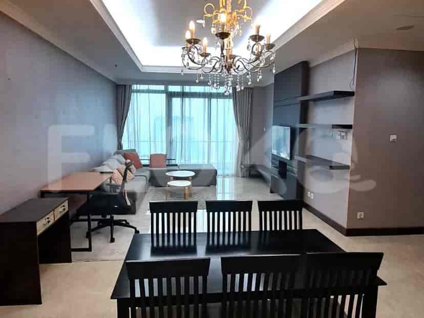 Spacious living room with an L-shaped grey sofa, dining area, and large window.