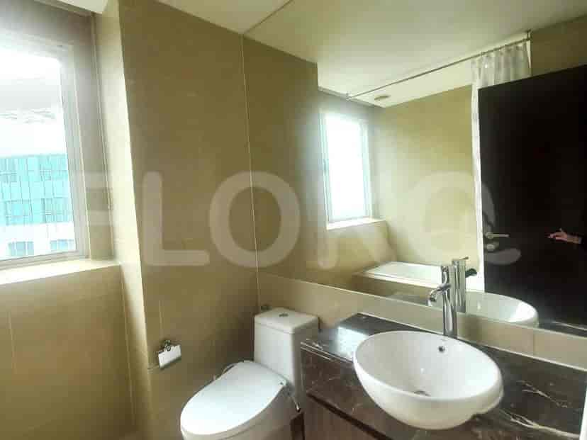 A bathroom with a modern design featuring a toilet, sink, and bathtub.
