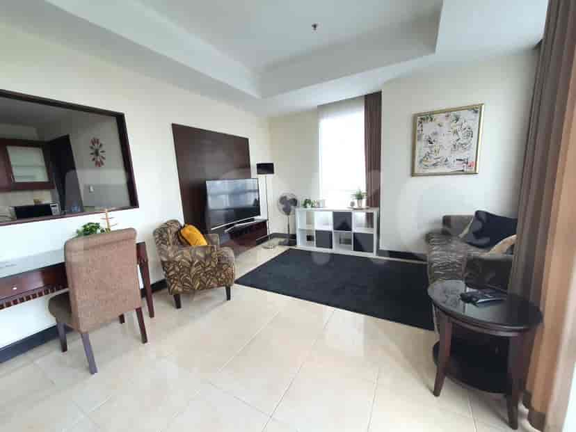 Living room with a sofa, TV, and side table.
