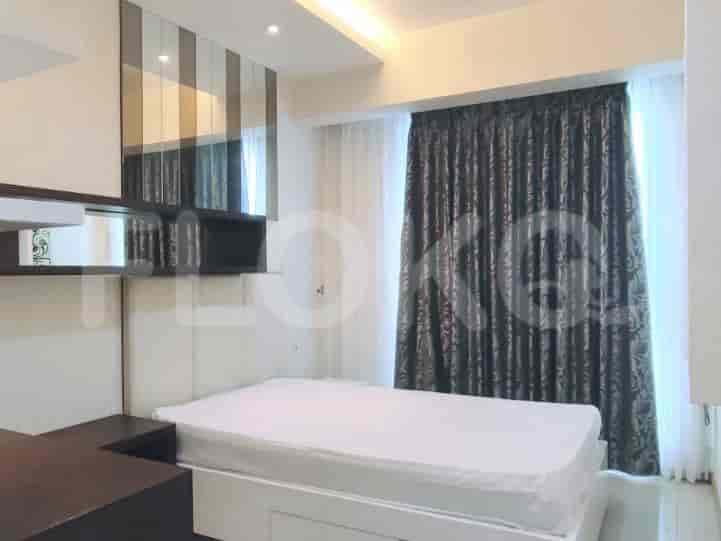 Bedroom with a bed, curtains, and a desk area.