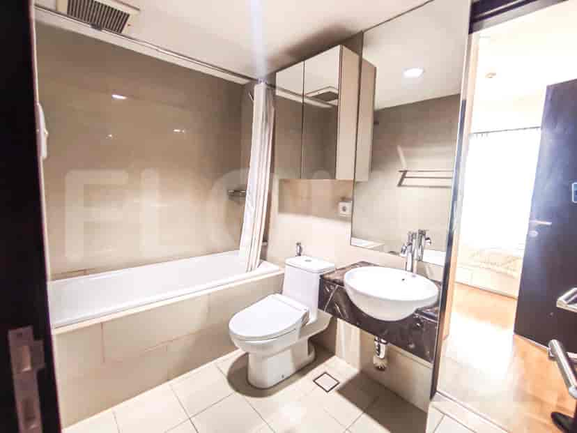 A bathroom with a bathtub, a toilet, a sink, and a mirror.