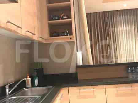 Modern kitchen with wooden cabinets, a stainless steel sink, and a built-in microwave.