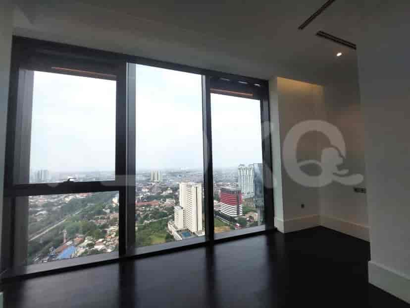 Bedroom with large windows and city view.