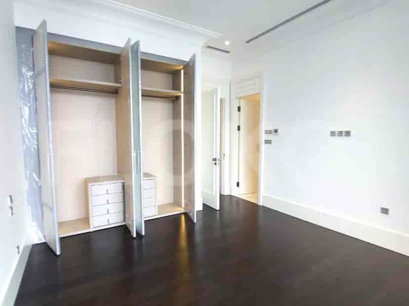 Bedroom with wooden floors and a closet.