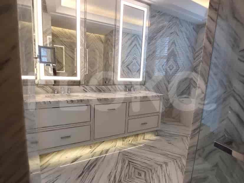 Modern bathroom with marble and large mirrors.