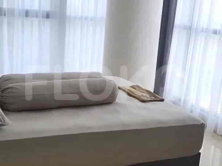 Bedroom with double bed and large windows with sheer curtains.