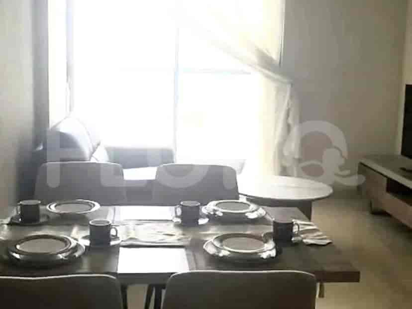 Dining area with a wooden table set for a meal, near a window.