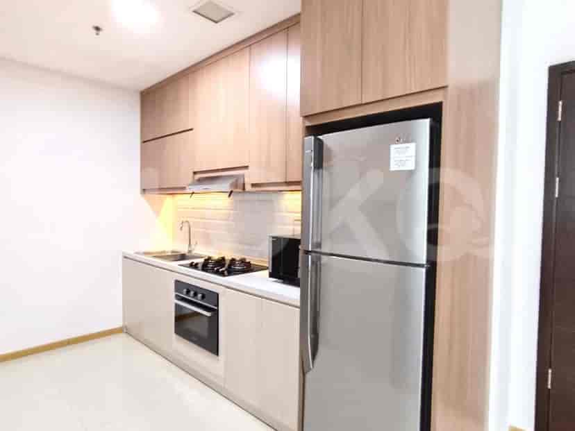 A modern kitchen with wooden cabinets, stainless steel appliances, and a built-in oven.