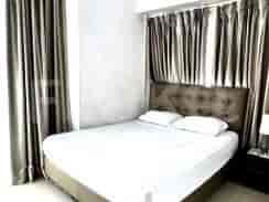 Bedroom with a bed and curtains.