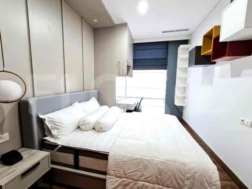 Bedroom with a bed, study desk and built-in closet.