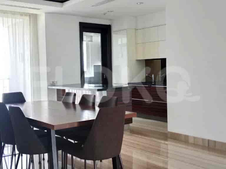 Dining area adjacent to a modern kitchen.